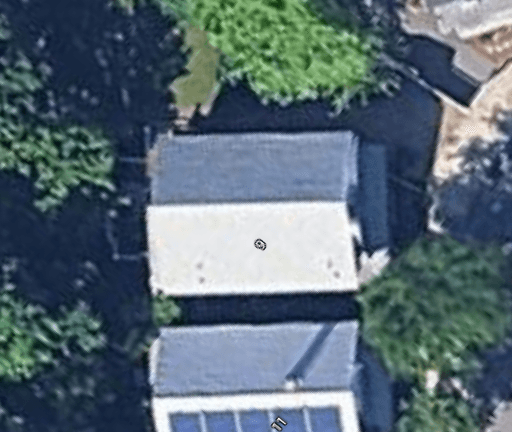 Satellite view of a residential roof with measurement overlay
